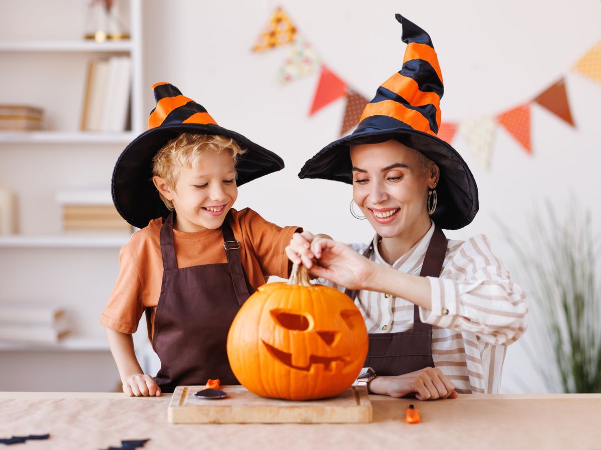 Cute,Happy,Little,Boy,Helping,His,Mother,To,Carve,Halloween