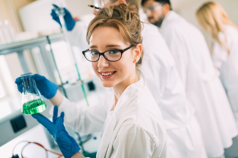 Female student of chemistry working in laboratory